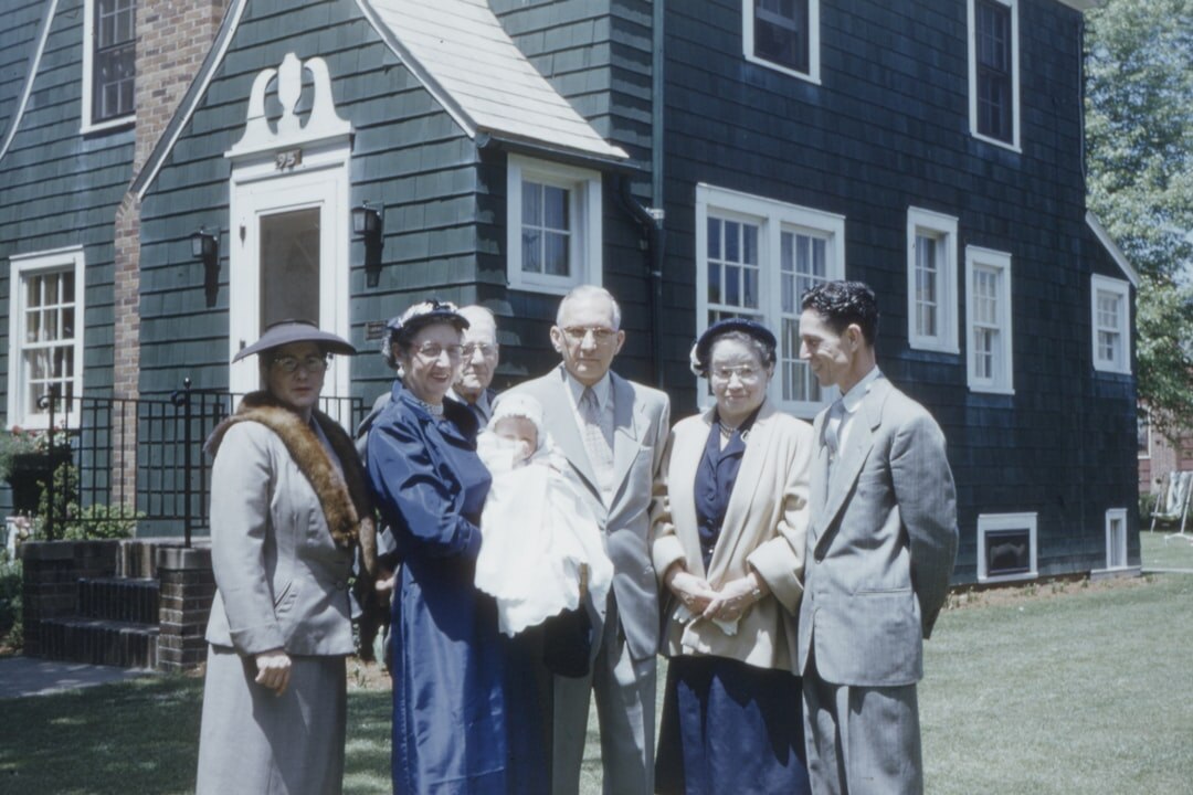 family standing in front of house